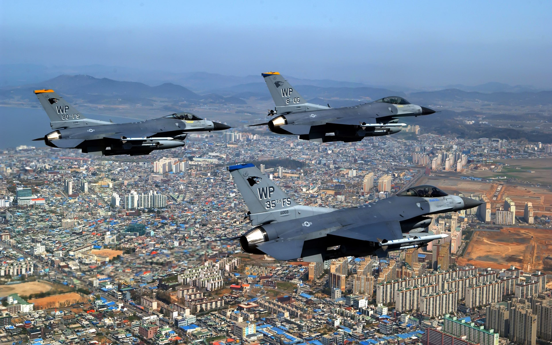 F 16 Fighting Falcons Over City9904517447